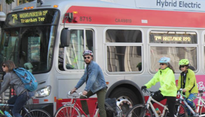 bikers and bus on street