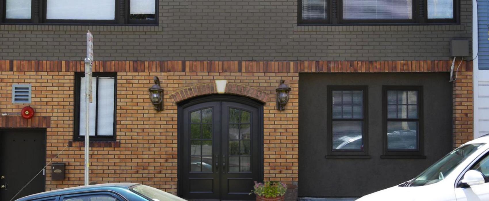 exterior of building with garage door converted to apartment for additional living space