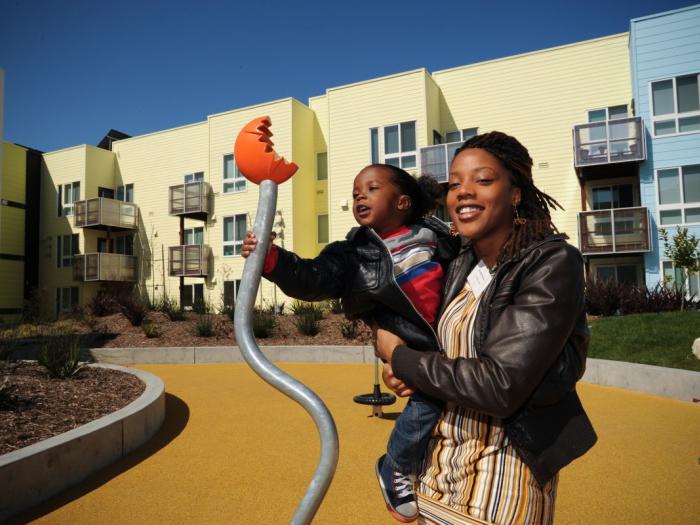 Smiling mother with young child at playground