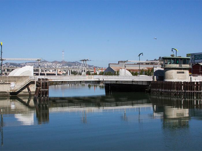 View of Islais Creek and bridge, with Sutro Tower in distance